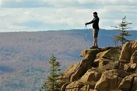 3 monts 4 a man standing on a rock with poles
