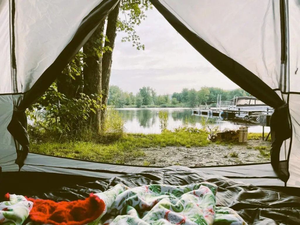 a tent with a view of a lake and trees